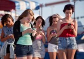 15433187-young-woman-at-amusement-park-using-their-phones